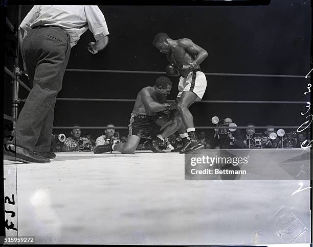 Chicago, Illinois- These sequence photos show the drama, the beginnning of the end as Archie Moore went down to the canvas for the first time, in the...