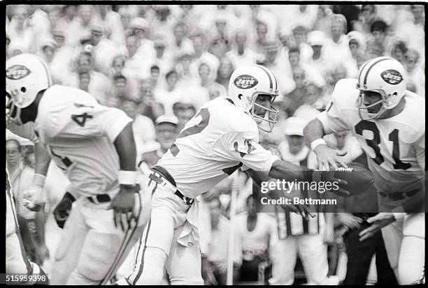New Haven, CT-Jets' quarterback Joe Namath hands off to Bill Mathis during the first quarter of action at Yale Bowl. The Jets demolished the Giants...