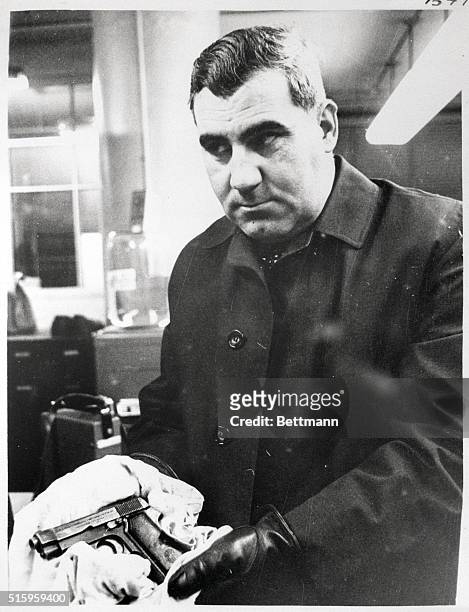 Lynn, MA- Detective Phillip J. DiNatale, of the Attorney General, office holds the .32 caliber automatic Beretta that was said to have been carried...