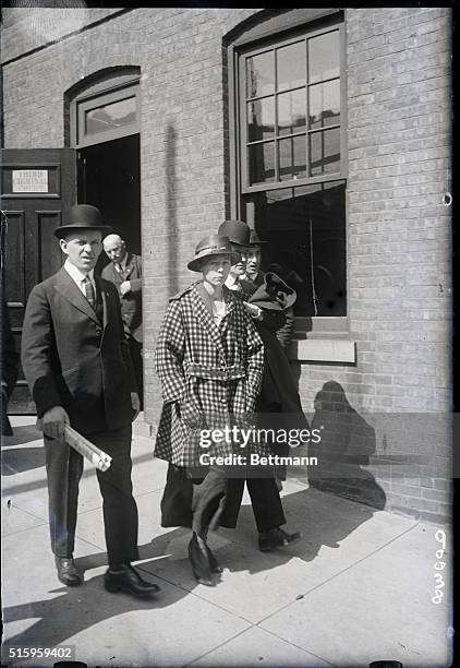 Mrs. Cora Hanglin, in custody of detectives on her way to be arrainged for manslaughter in the Second Criminal Court, Newark, NJ. The woman admits...