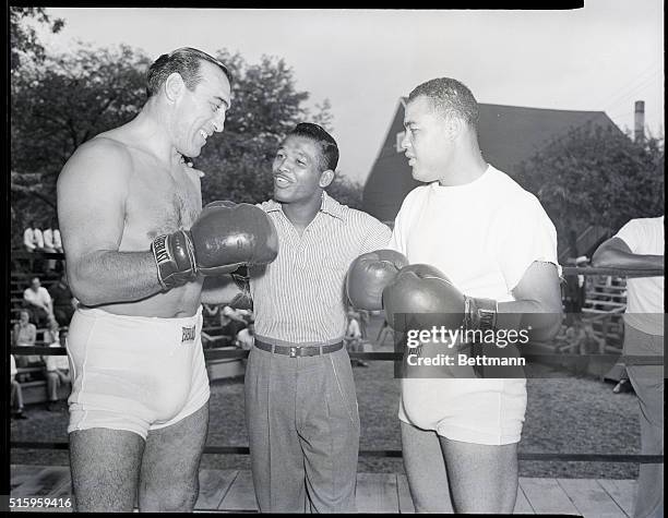 Pompton Lakes, NJ-In Joe Louis' corner at Pompton Lakes,where he is training to regain the crown he gave up for temporary retirement,we find a champ...