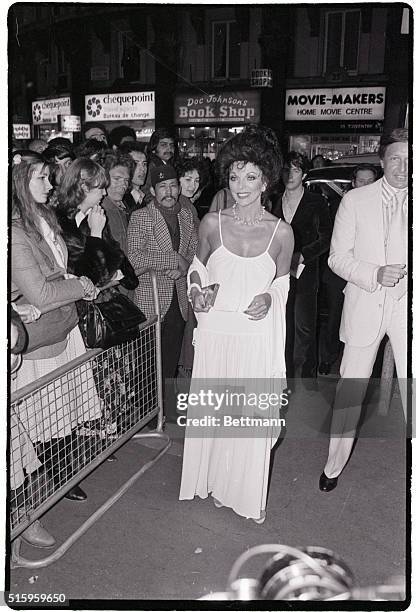 London, England-A radiant Joan Collins arrives at the Rialto Theatre in Leicester Square for the recent premiere of the movie "The Stud."