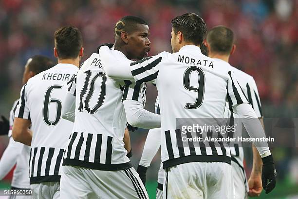 Paul Pogba of Juventus celebrates scoring his team's first goal with his team mate Alvaro Morata during the UEFA Champions League round of 16, second...