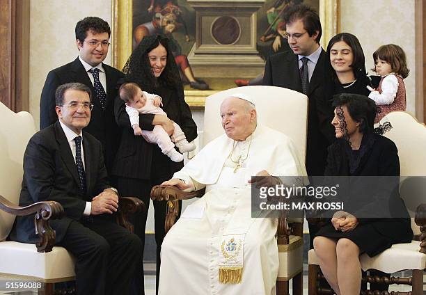 Pope John Paul II poses with the outgoing chairman of the European Commission, Romano Prodi , his wife Flavia and his family during a private meeting...