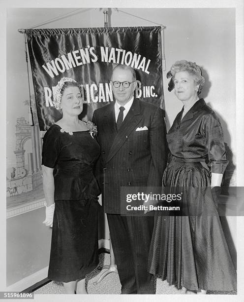 Mr. Ezra Taft Benson, Secretary of Agriculture standing with Mrs. Edward Anderson and Mrs. Edwin J. Hilson at the Women's National Republican club...