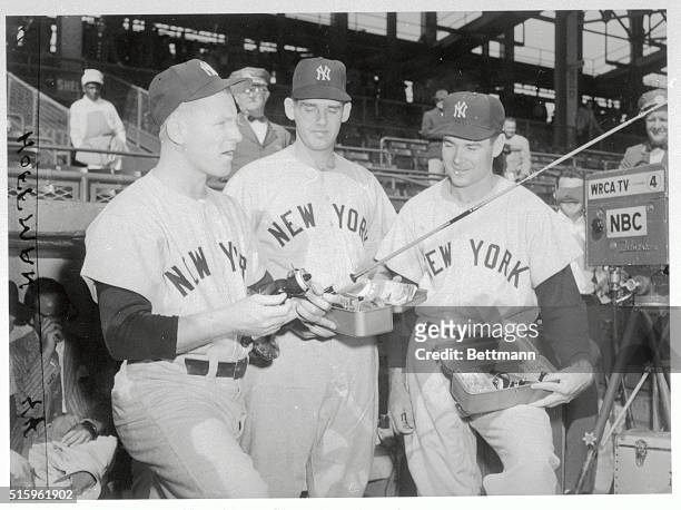 Whitey Ford, Don Larsen, Tom Sturdivant of the New York Yankees are shown here looking at fishing equipment.