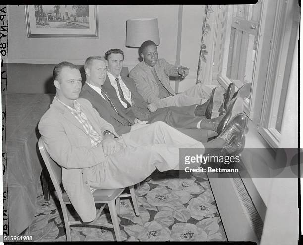Four of the high-riding Milwaukee Braves relax by the window-gazing Hotel Commodore. That's Hank Aaron pointing out something to teammates, , Ed...