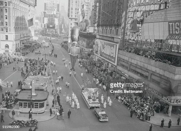 New York: Thanksgiving Day - Macy's Parade. Happy Holiday For Many...A Toy Soldier Balloon, paced by float bearing an American eagle, lords it over...