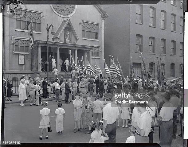 The "blessing of the flags" is shown here. The colors of the James F. Thompson Post No. 2546 Veterans of Foreign Wars is being carried into the...