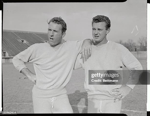 The L. A. Rams football workout is underway. The quarterback Bob Waterfield and Norm Van Brocklin is shown.