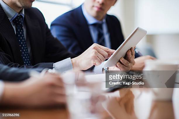 three businessmen meeting in a conference room. - japanese business bildbanksfoton och bilder