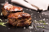Grilled steak meat (mignon) on the dark surface