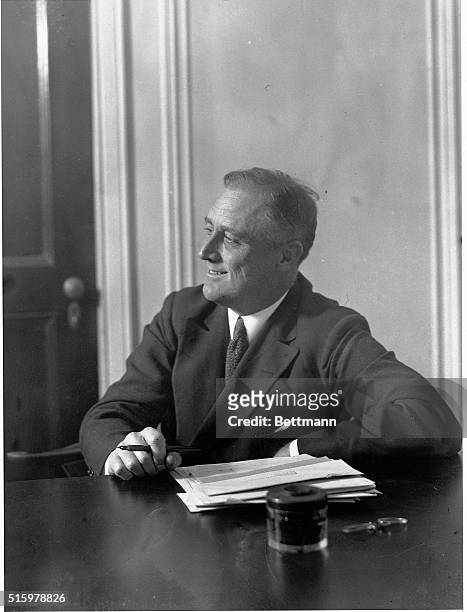 Photo shows Mr.Franklin D.Roosevelt the Democratic nominee for Governor of New York State as he appeared at his desk at the Roosevelt Headquarters in...