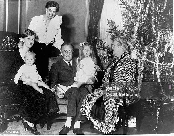Daughter of FDR and Eleanor Roosevelt Anna holds her son Curtis Dall, Jr., Eleanor Roosevelt stands behind the chair, New York Governor Franklin...