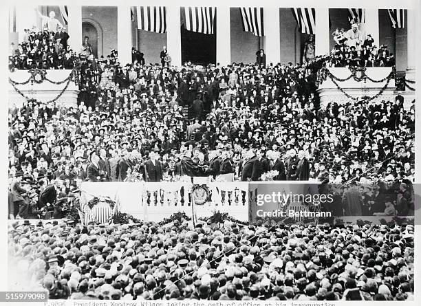 President Woodrow Wilson taking the oath of office at his inauguration, March 4, 1913. Photograph.