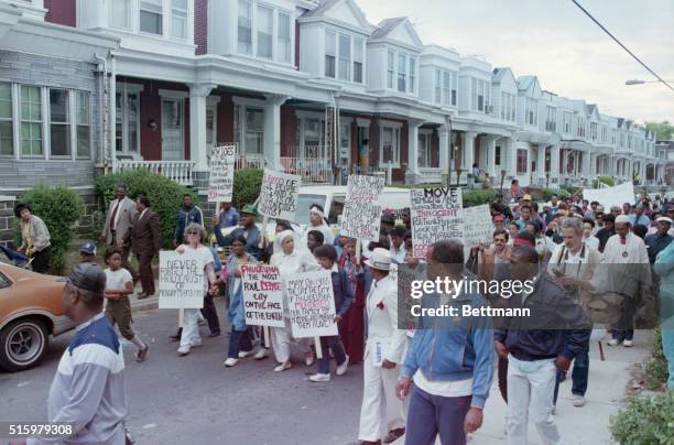 Philadelphia, PA- Relatives and supporters of the radical back-to-nature group MOVE conduct an anniversary march through the Osage street...