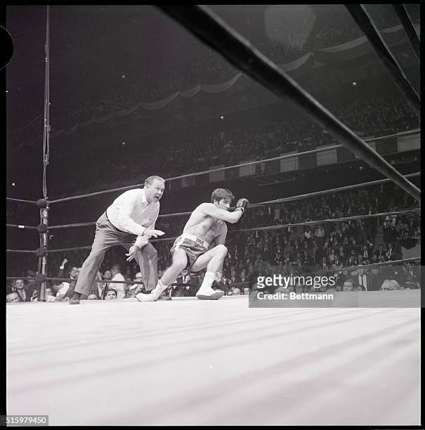 New York, NY- Italy's Nino Benvenuti staggers on the ropes after taking a long right on the side of the head from Emile Griffith in round four of...