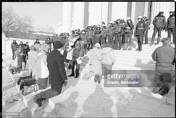 Washington, D.C. - Anti-abortion demonstrators kneel on the steps of the Supreme Court 1/22 in protest of the court's 1973 decision to legalize...