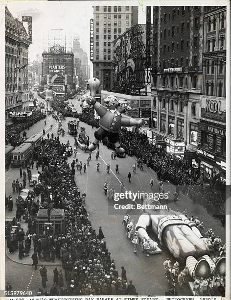 The 'Two-Headed Pirate' and 'Indian' character balloons in Macy's Thanksgiving Day Parade at Times Square, 26th November 1936.