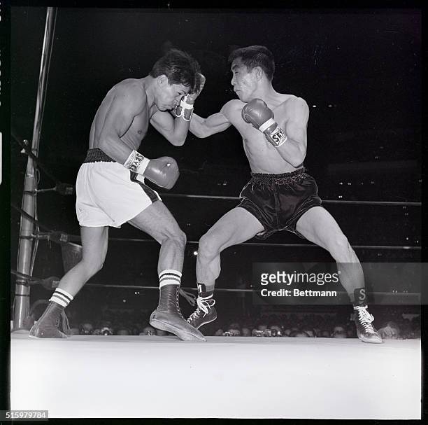 Mexico City- World featherweight champion Vincente Saldivar wards off a right to his head thrown by challenger Mitsunori Seki of Japan during their...