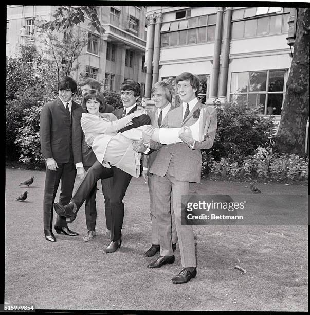 London, England- Kathy Sheron of Huntington, Long Island, is held aloft by the Dave Clark Five after arriving in London August 6th. Kathy, named...