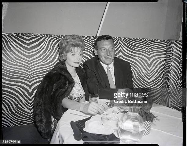 New York, NY: East 54th Street. Lucille Ball and Gary Morton are shown seated in the El Morocco Club. 1958.