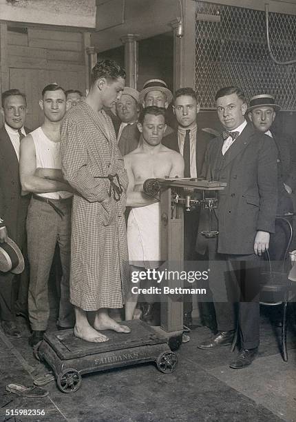 Photo shows Joe Burman on a scale and Jack Sharkey at a weigh-in before a fight.