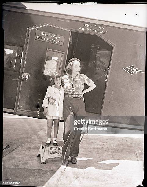 Burbank, CA- Lupe Velez, tempestuous Mexican film star, embraces her adopted daughter Conchita, upon arriving at United Airport in Burbank,...