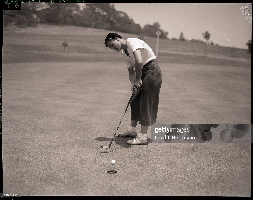 Babe Didrikson Putting on Golf Course