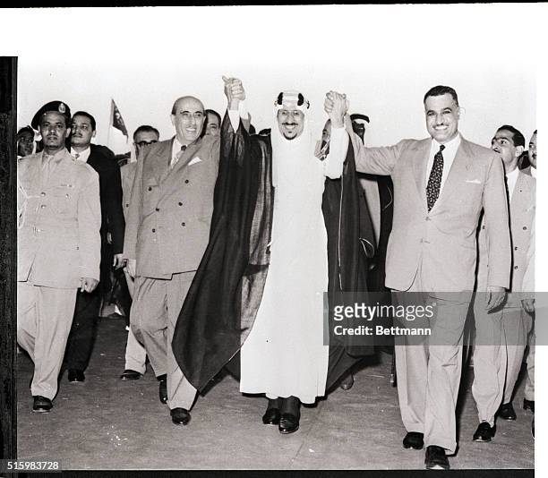 Dammam, Saudi Arabia- King Saud joins hands with Syrian President Shukri Al-Kuwatley and Egyptian President Gamal Abdel Nasser after Nasser and...