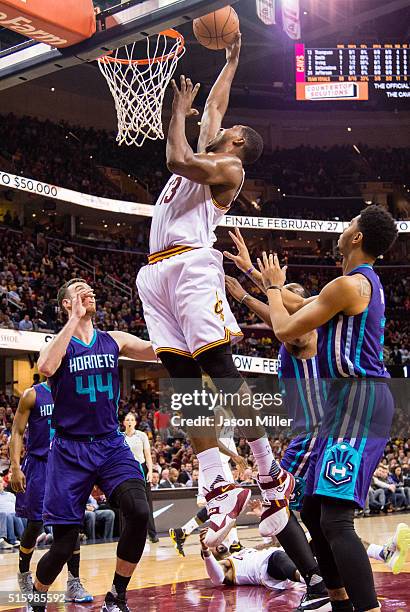 Frank Kaminsky III and Jeremy Lamb of the Charlotte Hornets guard Tristan Thompson of the Cleveland Cavaliers during the first half at Quicken Loans...