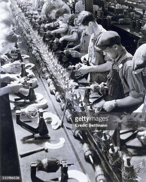 Ypsilanti, MI: Ford generators are made in a small plant at Ypsilanti, MI, about 2.5 miles from Dearborn. Photo shows an active assembly line as men...