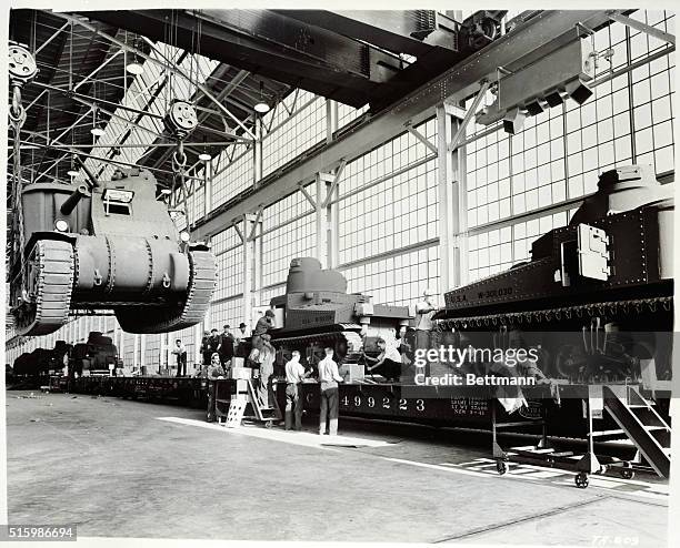Workers at a Chrysler plant assemble tanks.