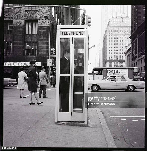 New York City: Telephone booth at 42nd Street and Lexington Avenue. Undated photo.