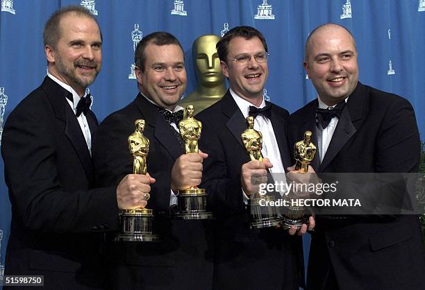 From L to R: John Nelson, Neil Corbould, Tim Burke and Rob Harvey hold their Oscars for Best Outstanding Visual Effects for their work on "Gladiator"...