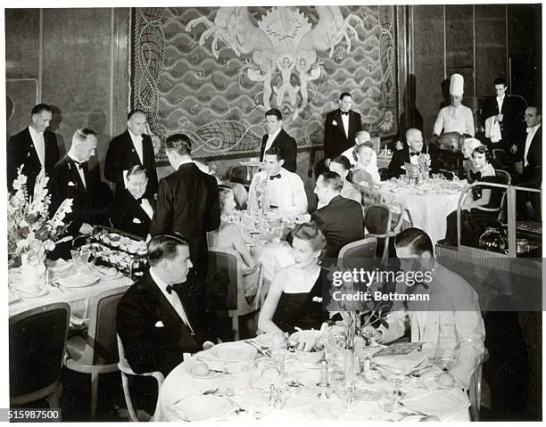 Photo shows the dining room of an ocean liner. In the right background, one of the chefs can be seen. Ca. 1940s.