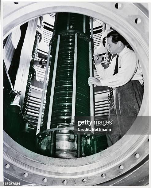 East Pittsburgh, PA: "Splitting the Atom." Dr. William H. Wells, in charge of the Westinghouse "Atom Smasher," testing a 40 foot vacuum tube through...