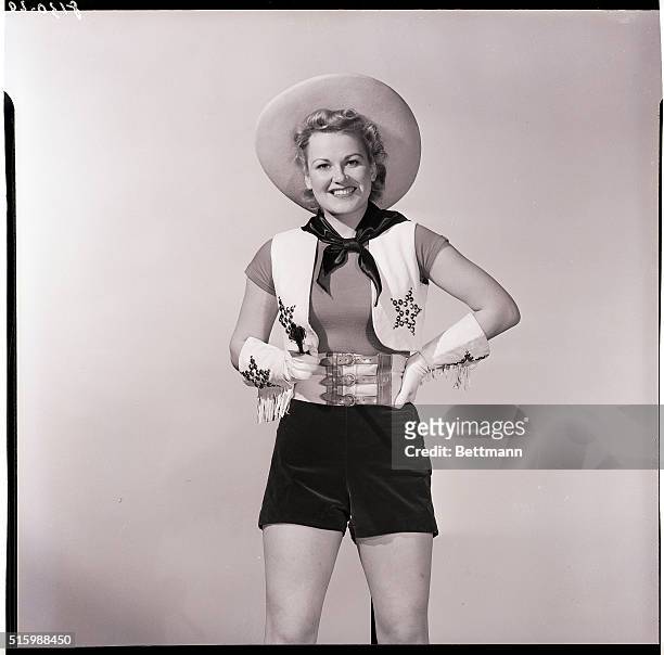 Photo shows a woman in a cowgirl outfit. 3/4 length. Model: Betty Jane Hess. Ca. 1940s.