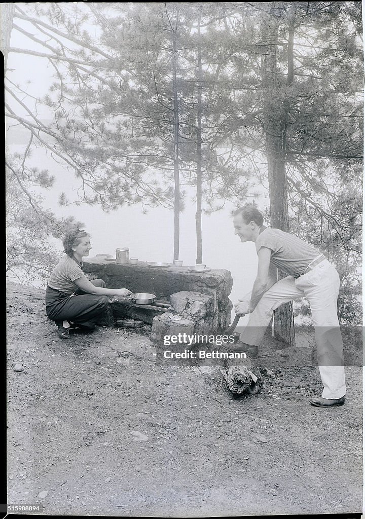 Couple Cooking While Camping