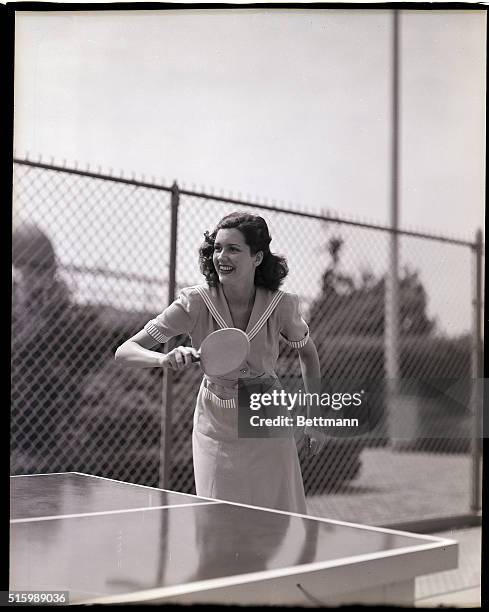 Portrait of a young woman playing ping pong. Undated photograph, circa 1950's.