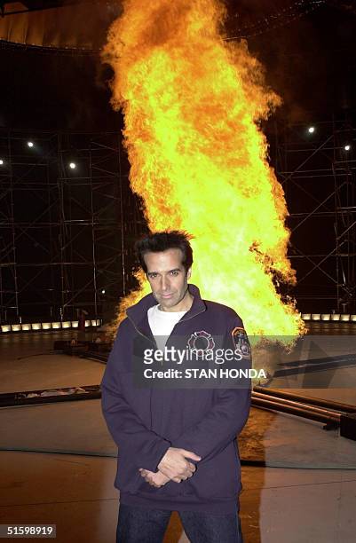 Illusionist David Copperfield stands in front of a "tornado of fire" 28 March 2001 at a press conference in New York. Copperfield will attempt to...
