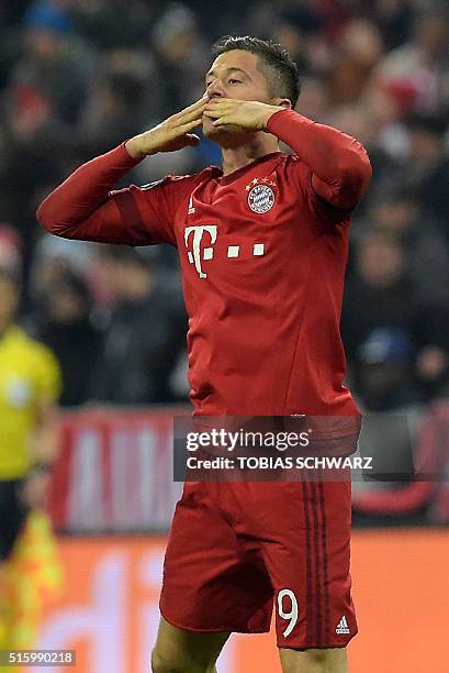 Bayern Munich's Polish striker Robert Lewandowski celebrate after scoring during the UEFA Champions League, Round of 16, second leg football match FC...