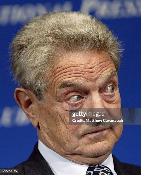 Financier and philanthropist listens to a question from the moderator at the National Press Club October 28, 2004 in Washington, DC. Soros, the...