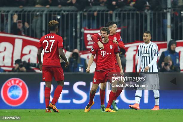 Thomas Muller of Bayern Muenchen celebrates scoring his team's second goal with his team mate Robert Lewandowski during the UEFA Champions League...