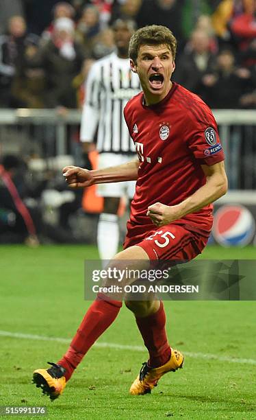 Bayern Munich's midfielder Thomas Mueller celebrates scoring the 2-2 goal during the UEFA Champions League, Round of 16, second leg football match FC...