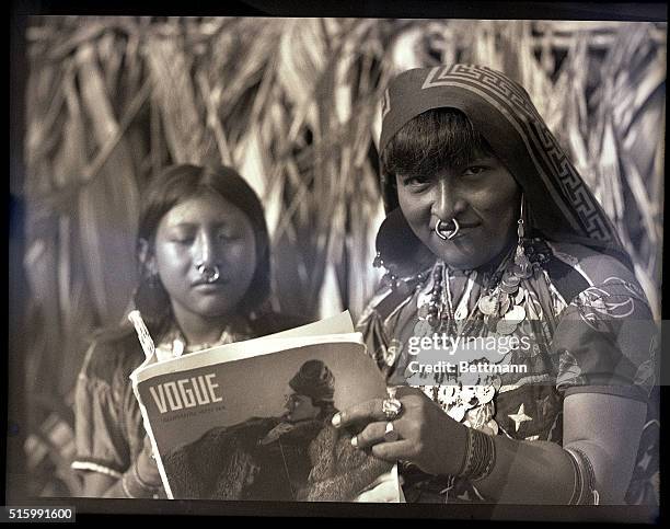 Photo shows two women from San Blas in traditional attire, holding a Vogue magazine. Undated.