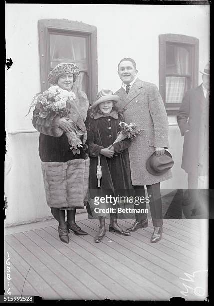 Johnny Kilbane, featherweight champion, with Mrs. Kilbane and their daughter Mary, who sailed on the Aquitania for London and other European centers...