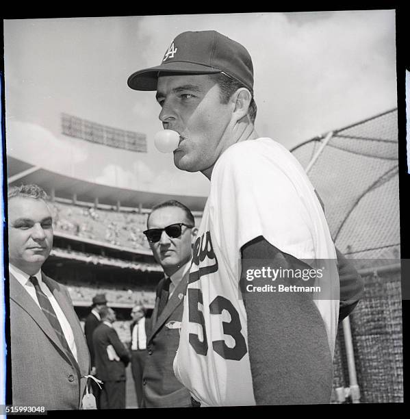 Los Angeles, California- At Dodger Stadium, Los Angeles Dodgers' starting pitcher Don Drysdale obliges photographers as he poses for pictures blowing...