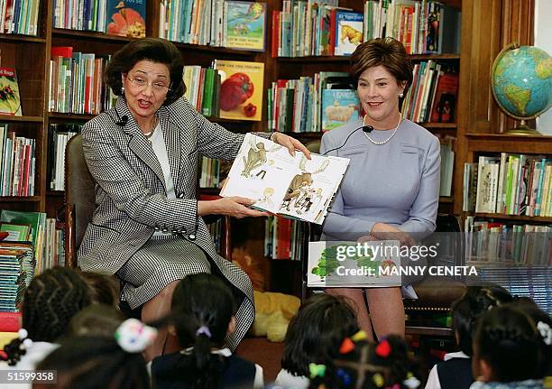 Suzanne Mubarak , wife of Egyptian President Hosni Mubarak reads a story to children as US First Lady Laura Bush looks on during a celebration of...