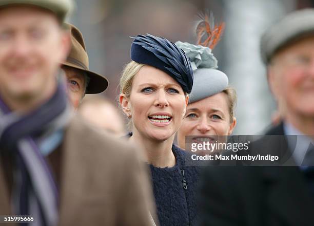 Zara Phillips and Dolly Maude watch the Queen Mother Champion Chase as they attend day 2, Ladies Day, of the Cheltenham Festival on March 16, 2016 in...